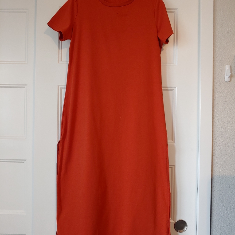 Long plain dress with slits on both sides.